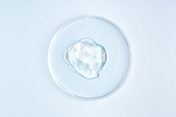 laboratory glass petri dish with drop of gel beauty product. Natural medicine, cosmetic research, bio science. Concept of skincare, analysis. Dermatology. Flat lay