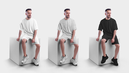 Mockup of a white, black anf heather men's oversized t-shirt with shorts on a man on a cube.
