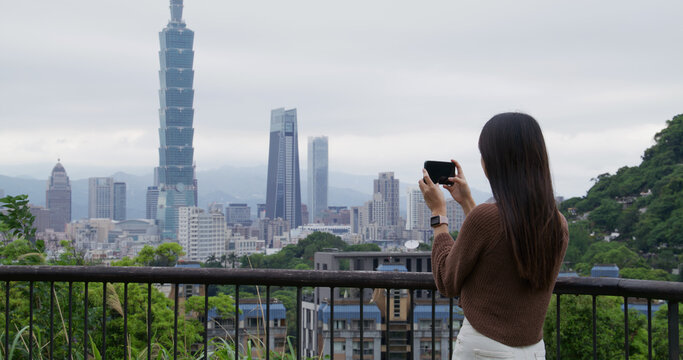 Woman take photo on the Taipei city