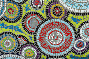 Ceramic mosaic with kaleidoscope circles from broken tiles.