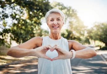 Fotobehang Oude deur Fitness, happy and heart hands of old woman in nature after running for health, wellness and workout. Smile, motivation and peace with senior lady and sign for love, faith and training in nature