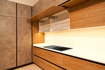 Modern brown wood oak kitchen cabinet equipment and granite black sink in a home