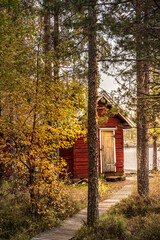 Fototapeta na wymiar kleines gemütliches rotes Holzhaus am See, Schwedenhaus