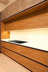 Modern brown wood oak kitchen cabinet equipment and granite black sink in a home