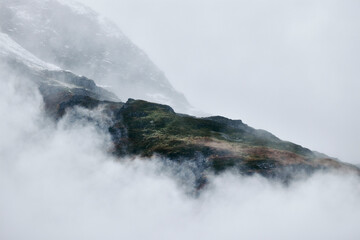 cloudy mountains in alaska some green forest