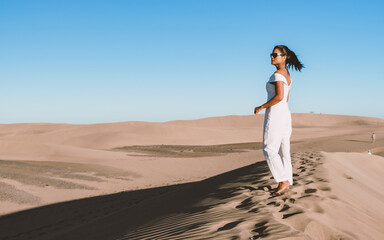 young woman at the dessert of Maspalomas sand dunes Gran Canaria during vacation at the Canary...