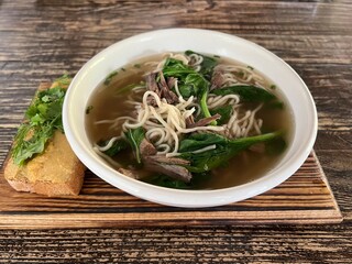 meat soup with noodles and spinach
