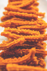 Bhajni chakli sticks or crunchy murukku snack made using diwali festival, favourite munching food