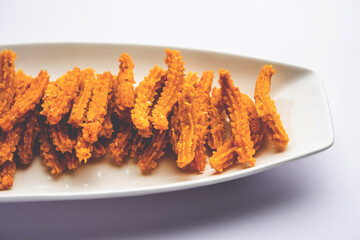 Bhajni chakli sticks or crunchy murukku snack made using diwali festival, favourite munching food