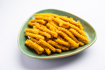 Bhajni chakli sticks or crunchy murukku snack made using diwali festival, favourite munching food