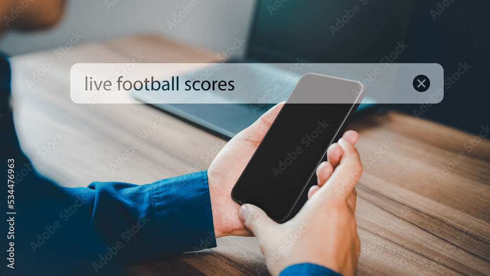 Poster Football fan's working in office with holding smartphone for search live football scores. Searching Browsing Internet Data Information with search bar. Search Engine technology networking Concept.