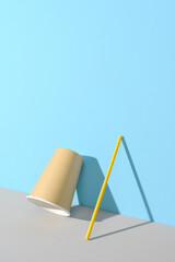 Eco friendly stripped paper straw and cup leaning against the color wall. Recycling, biodegradable concept. Minimal geometric scene with copy space.