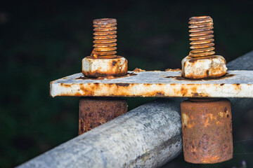 Close-up of rusty on nut and bolt isolated of metal roller, Roller suport steel door, Selective focus.