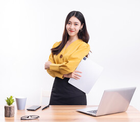 A business woman standing at her desk in a short black dress