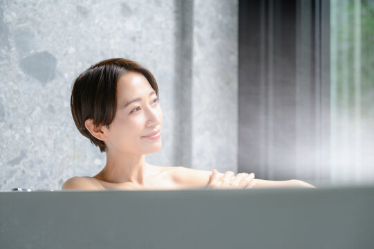 お風呂の湯舟でくつろぐ女性