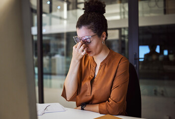 Stress, burnout and woman with a headache tired from working overtime at her office desk due to...