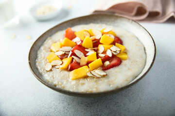Homemade oatmeal porridge with strawberry and mango