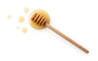 Wooden honey dipper with honey on white background.