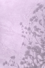 Shadow of flowers on purple concrete wall texture with roughness and irregularities. Abstract trendy colored nature concept background. Copy space for text overlay, poster mockup flat lay 
