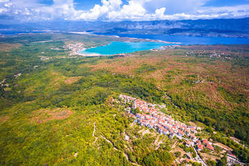 Historic town of Dobrinj and turquoise Soline bay aerial panoramic view