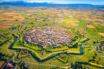 Star shape town of Palmanova defense walls and trenches aerial panoramic view - 534488332