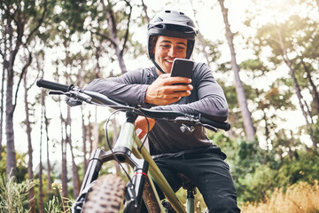Cyclist, phone and bike happy in forest on ride for fitness, health and wellness. Man, smartphone...