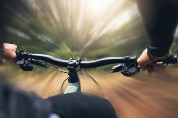 Hands, man and cycling skills while on a bicycle outdoor in a forest. Adrenaline junkie practice,...