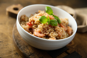 Healthy quinoa bowl with shrimps and basil