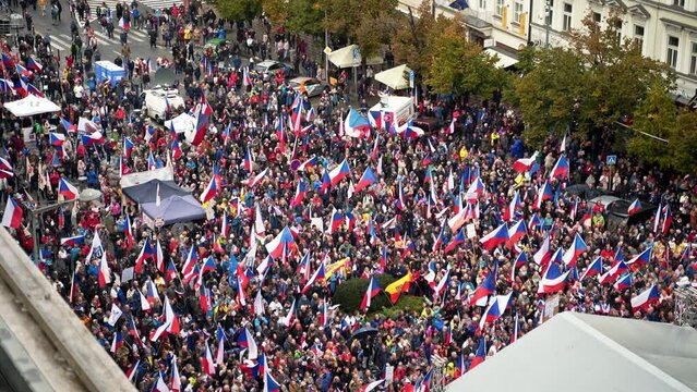 Nationalist crowd with czech flags at Prague demonstration, high angle.