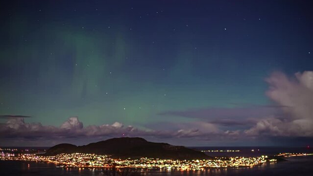 Northern Lights (Aurora Borealis) Over Town Of Alesund In Norway. time lapse