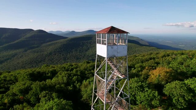 Catskill Mountains Fire Tower. Late summer drone shot of mountain peaks and forests.