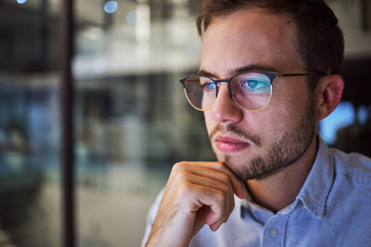 Man, Work And Reading With Reflection On Glasses In Office Thinking Of Planning Strategy For Business. Businessman, Working And Screen Of Tech At Company, Workplace Or Corporate In Overtime In Night