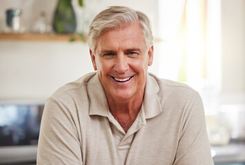 Relax, happy and face of elderly man smiling, cheerful and relaxing in a living room at home, carefree. Retirement, relaxation and mature male enjoying his retired lifestyle alone in his house