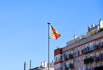 Valencian Community flag is an autonomous community of Spain. Spain flag on blue sky background.