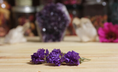 Obraz na płótnie Canvas Amethyst Crystals With Flowers on Meditation Table