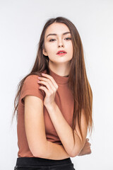 Naklejka premium Portrait of a young beautiful brunette model, isolated on white background
