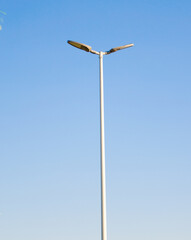 electric lighting pole. Blue sky. Park lighting pole.
