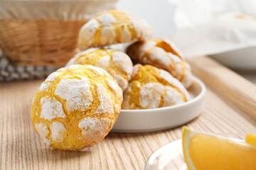 Tasty homemade lemon cookies on wooden tray, closeup