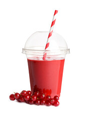 Plastic cup of tasty currant smoothie and fresh fruits on white background