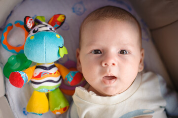 Close-up detail portrait of cute little peaceful newborn baby boy child face with beautiful open eyes. Love and family emotion