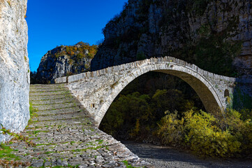 Fototapeta na wymiar View of the traditional stone Kokkorou Bridge in Epirus, Greece in Autumn.