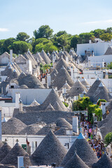 ALBEROBELLO, ITALY, 19 AUGUST 2021 Tourists in Alberobello, town with typical houses called...