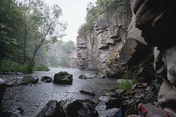 Climbing area Buksky canyon, rain on the Gorsky Tikich river near high granite rocks, Cherkasy...
