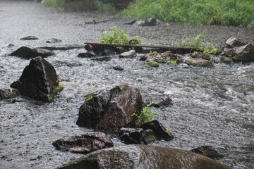 Rain on the river Gorsky Tikich rocky banks near high granite rocks. Buksky canyon, Cherkasy region