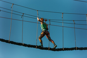Skilled adult woman in the adventure park
