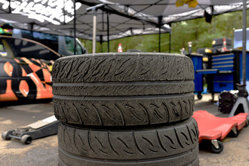 Old Tyres after racing. Tires of race car for driving. Drag and drift car with lower-profile tire....