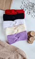 Fashionable knitted headbands autumn-winter. The headbands lies on a white background. Product layout. Knitting. Hobby.