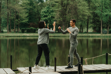 Boy boxing with his girlfriend on the bridge