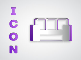 Paper cut Sofa icon isolated on grey background. Paper art style. Vector