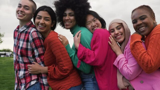 Happy young multi ethnic women having fun together in a public park - Diversity and friendship concept 